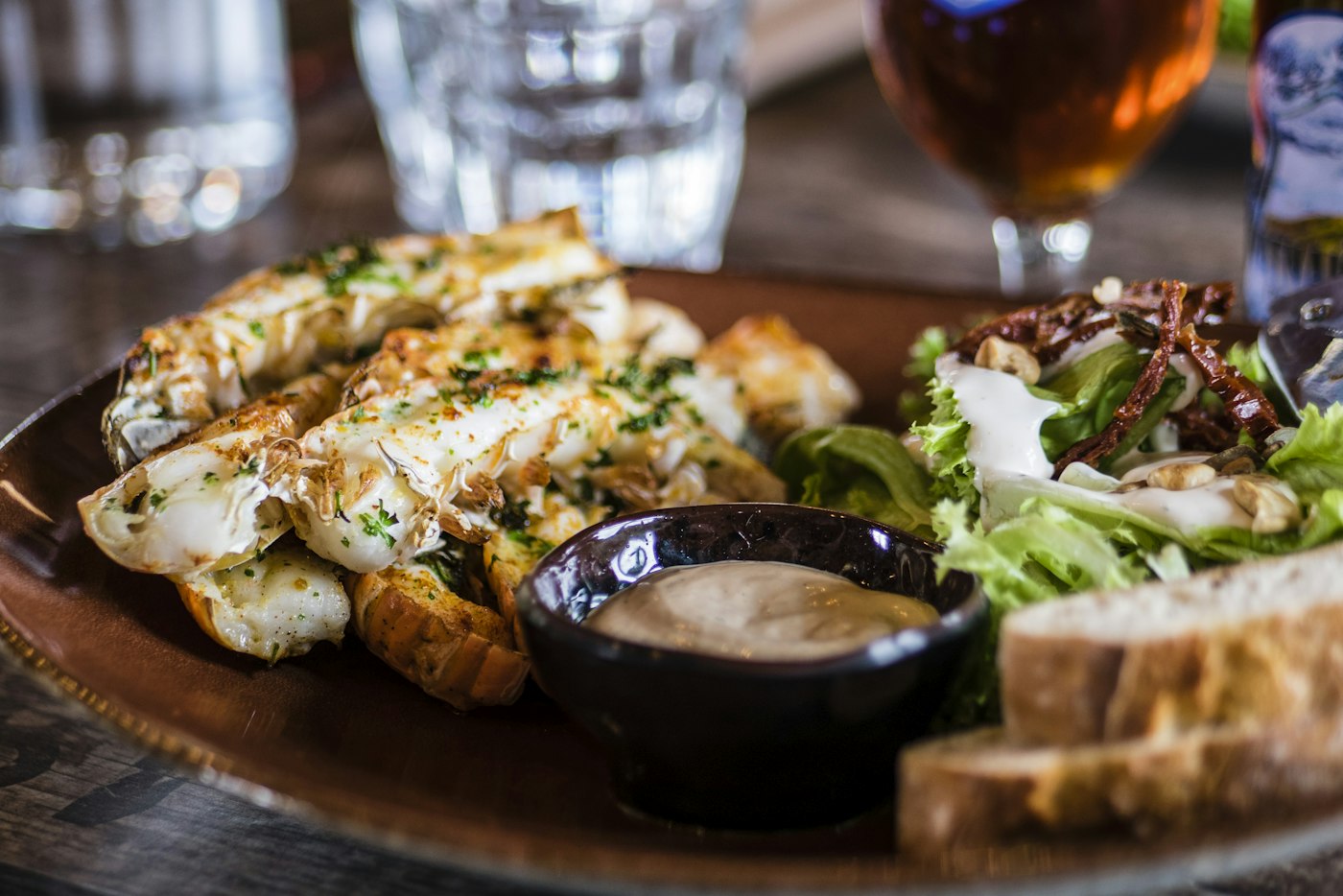 A composed dish of meat and greens on a light plate