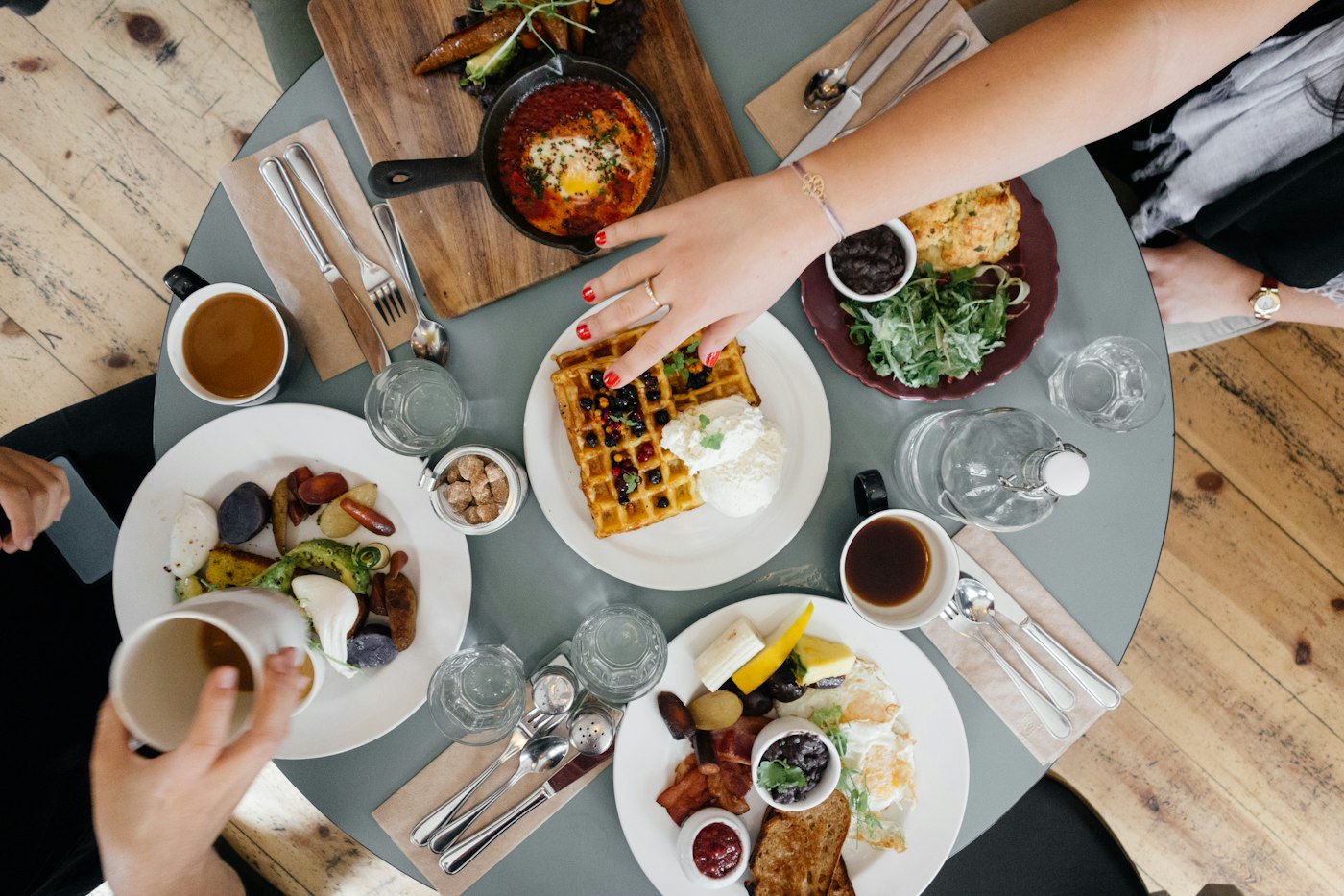 A restaurant table set with plates and glasses