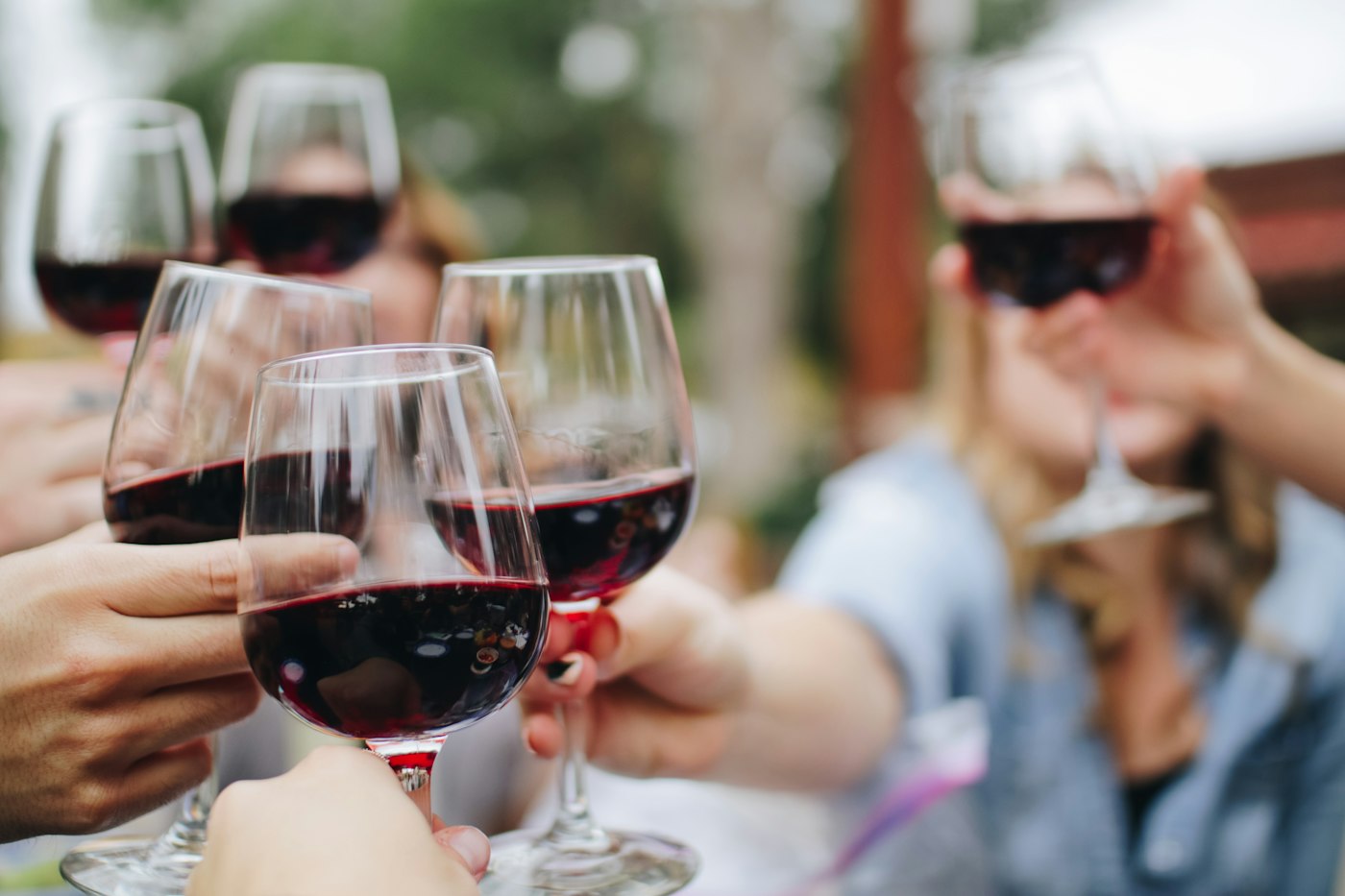 Wine poured into a glass beside a bottle