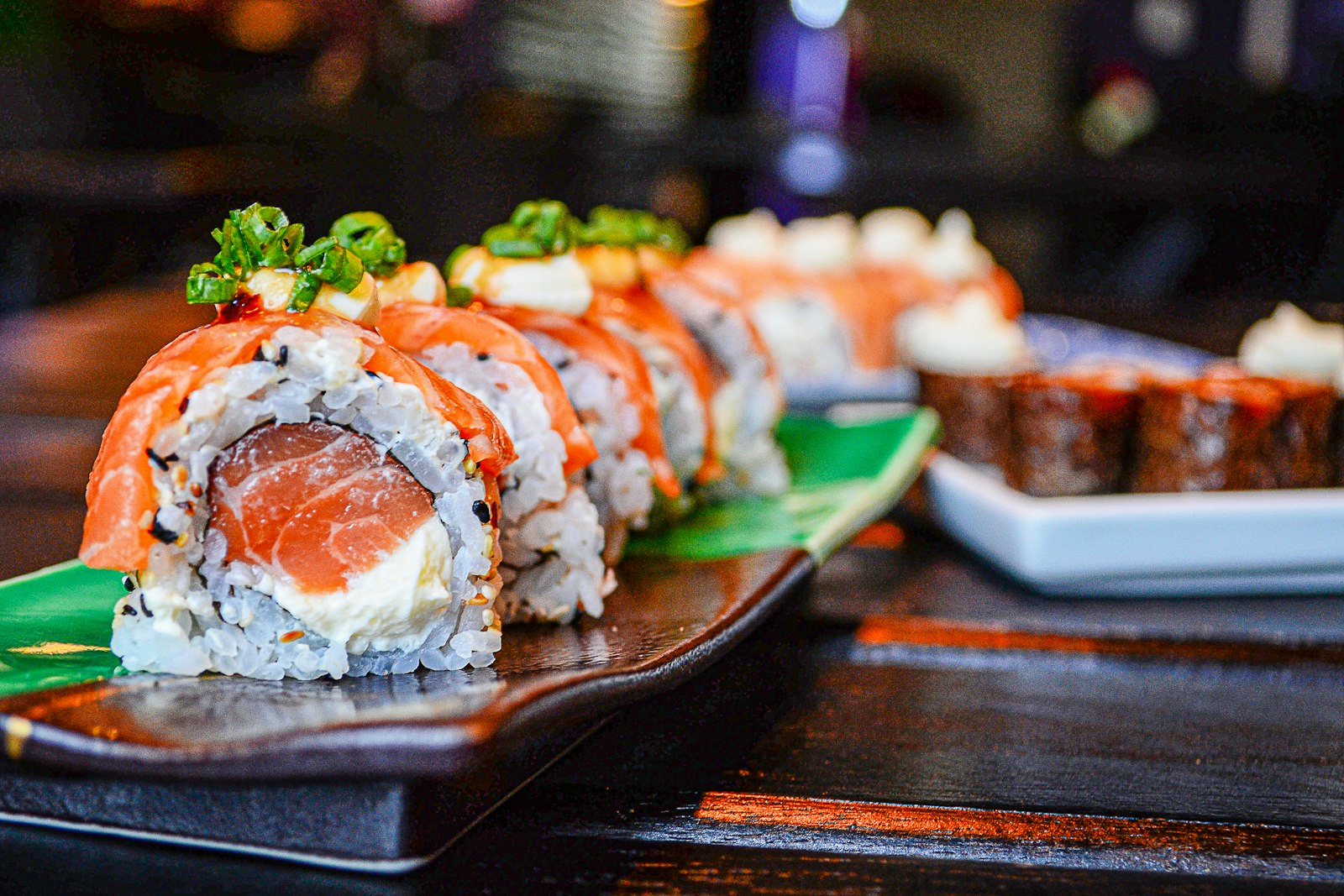 Assorted nigiri sushi on a dark slate