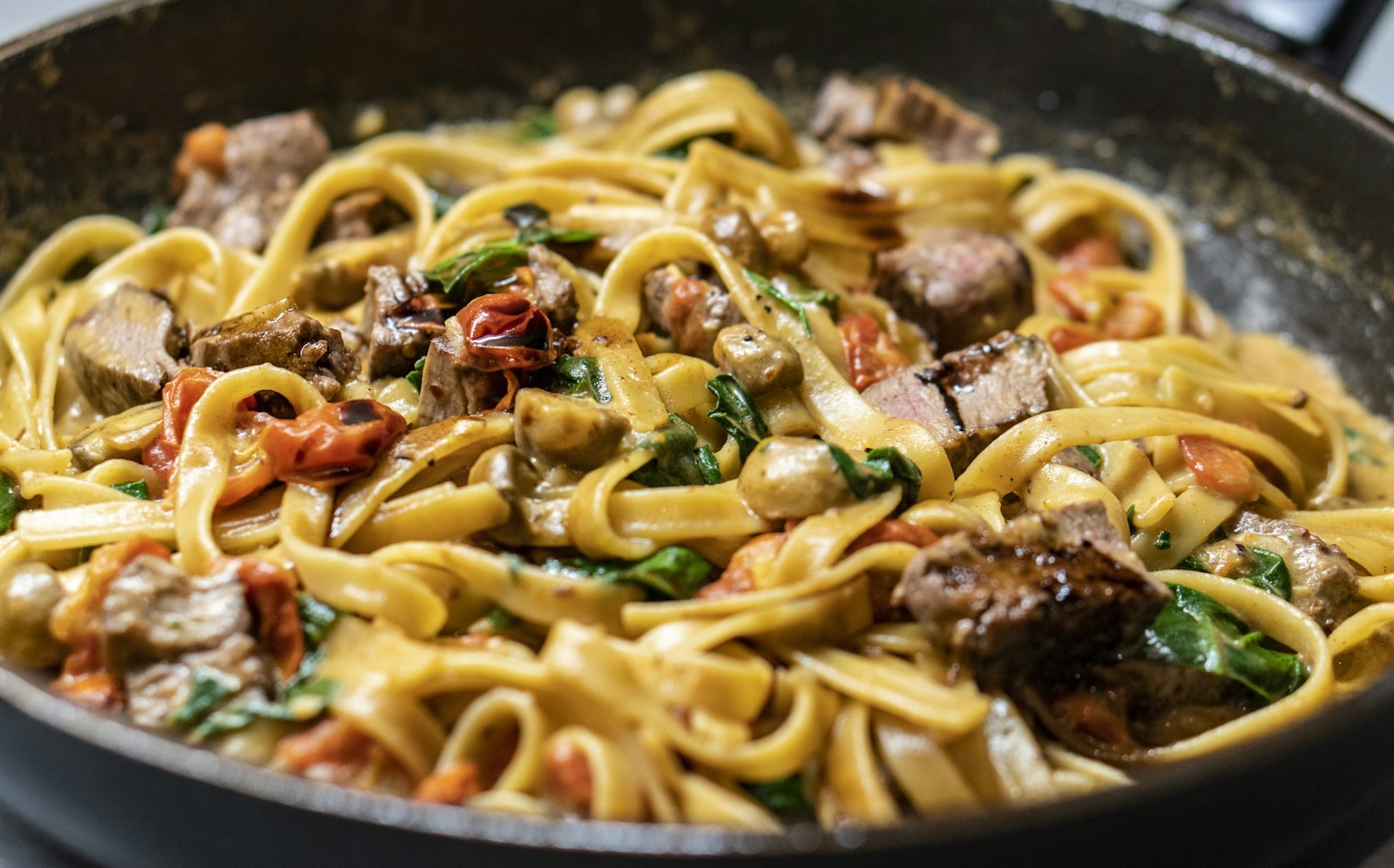Handmade pasta with tomato sauce and basil
