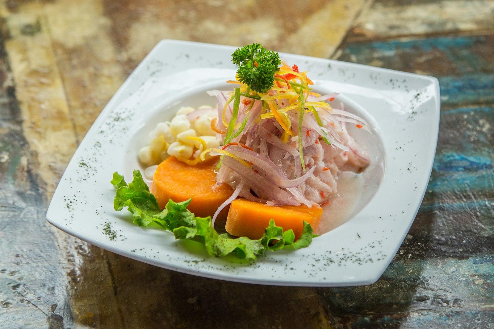 Ceviche with sweet potato, corn, and sliced onion