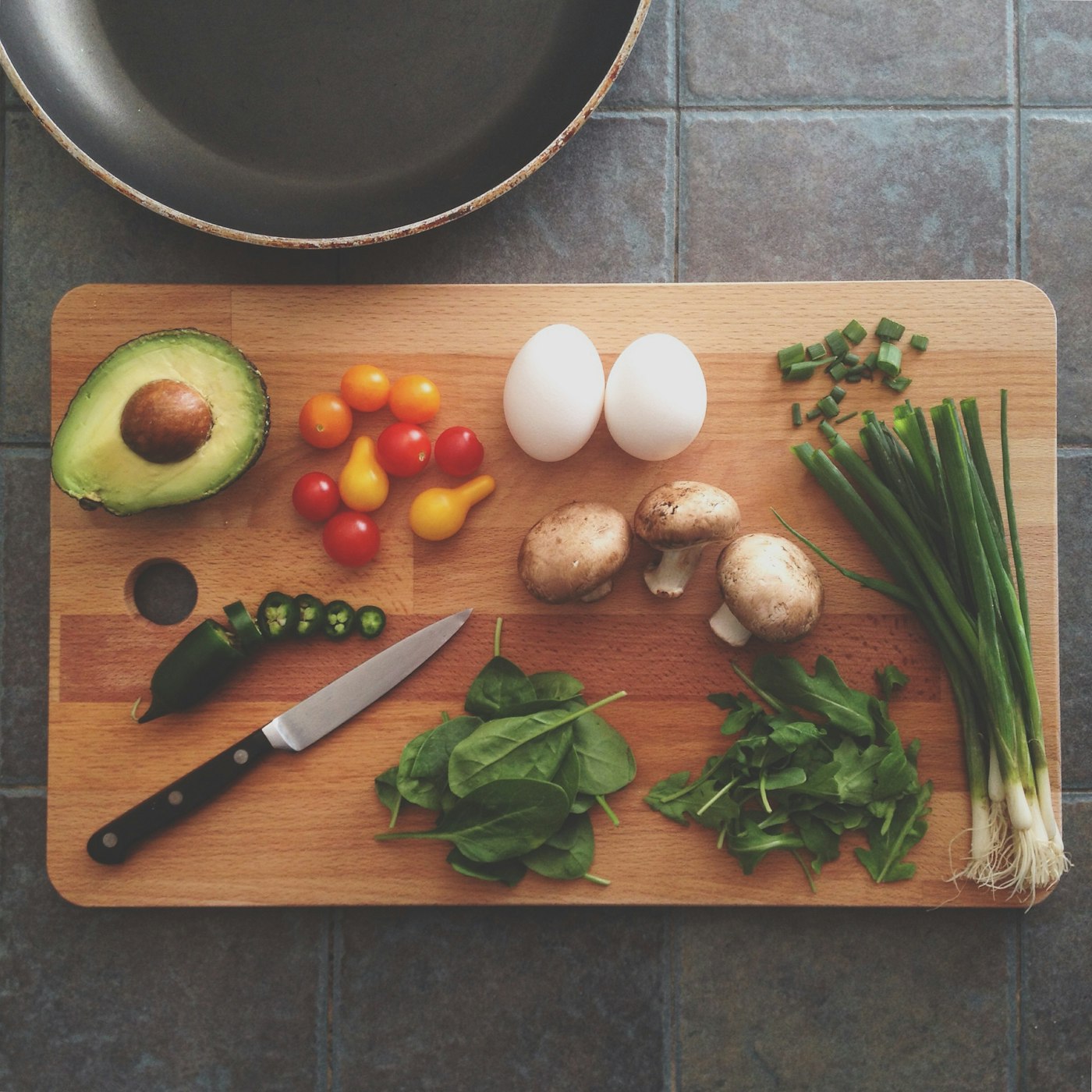 Hands arranging greens on a plate